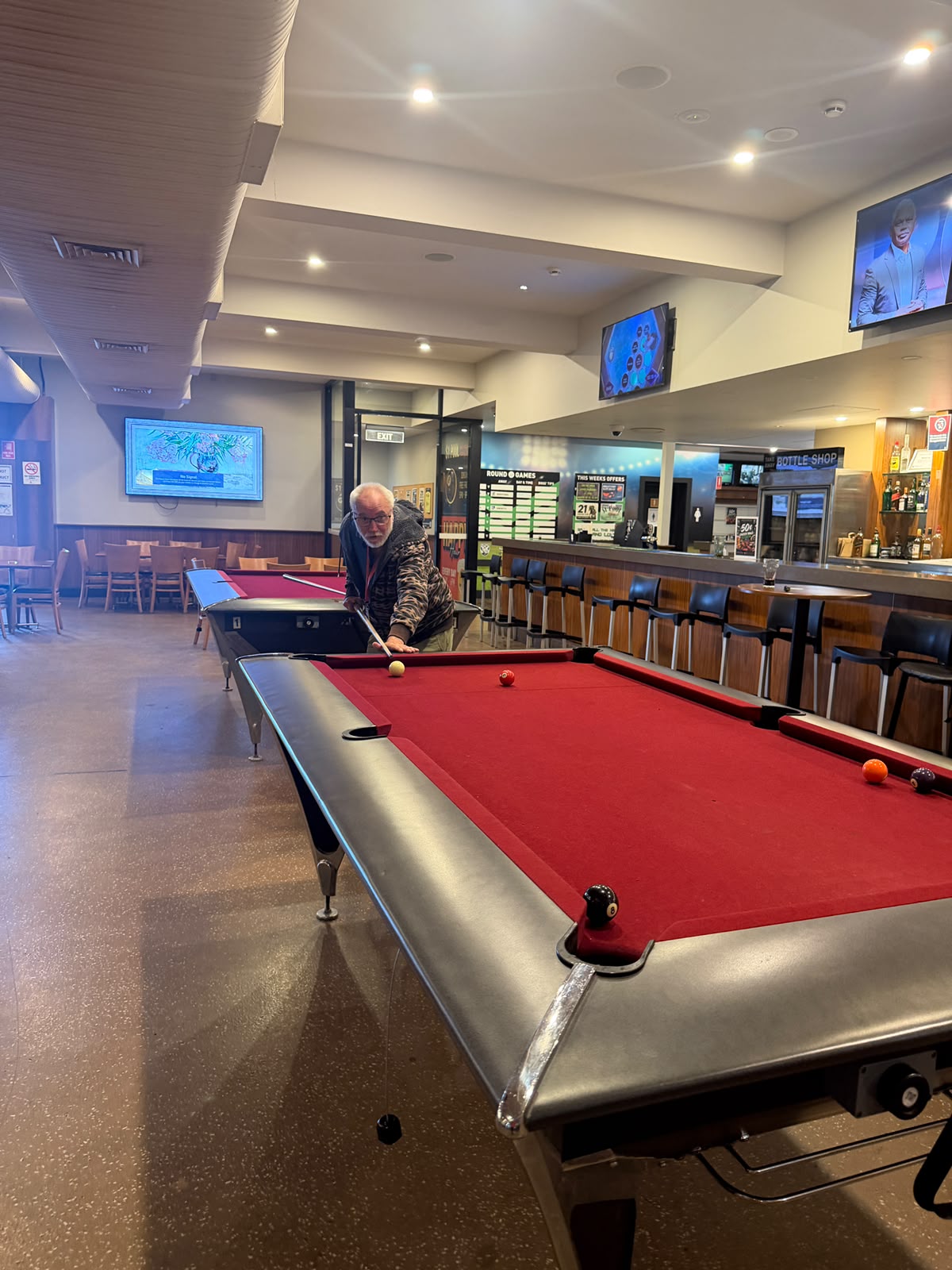 A person enjoying a game of pool